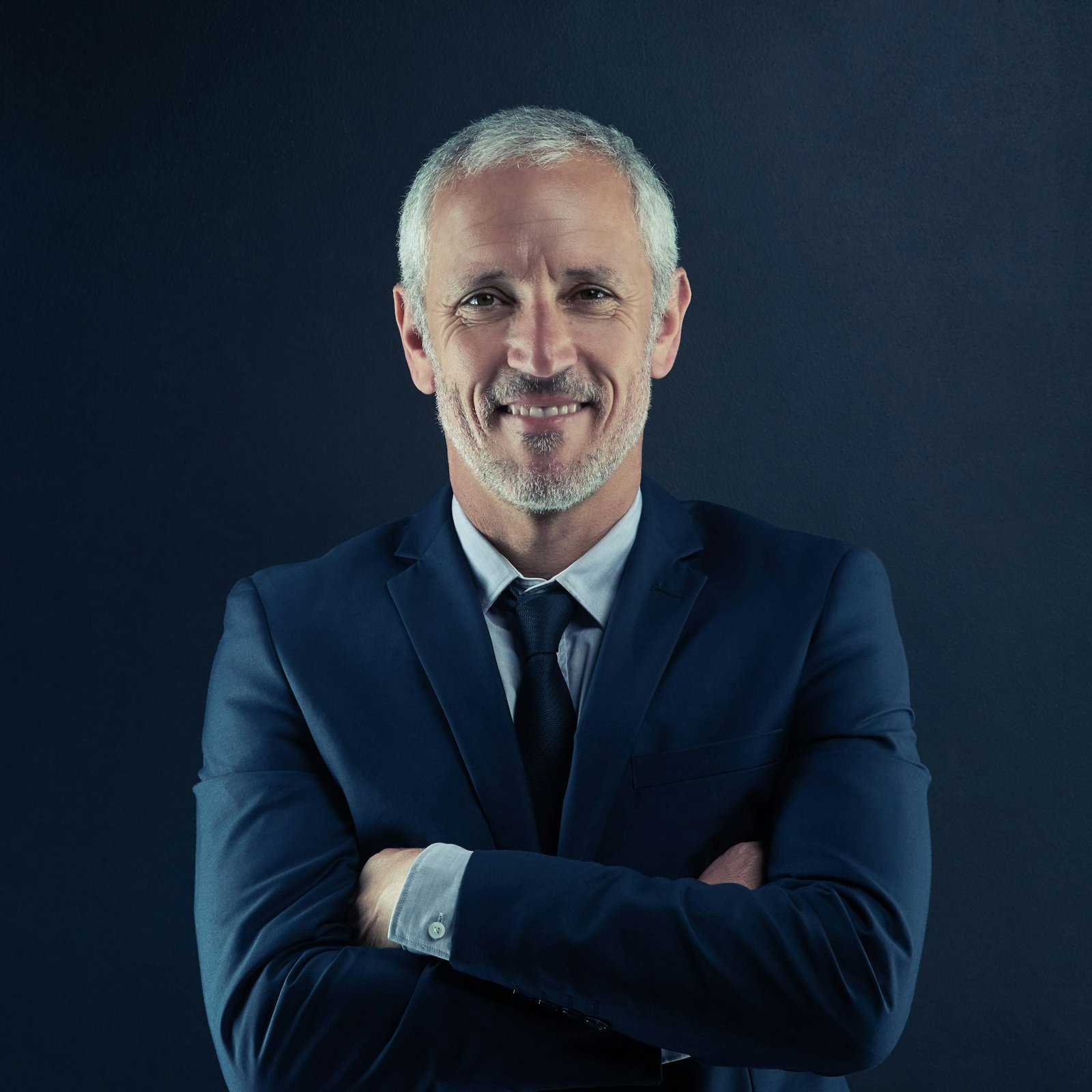 studio portrait of a mature businessman against a dark background